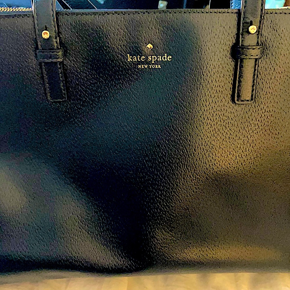 Brand new (WOT) Kate Spade everyday tote in deep Navy with golden accents.